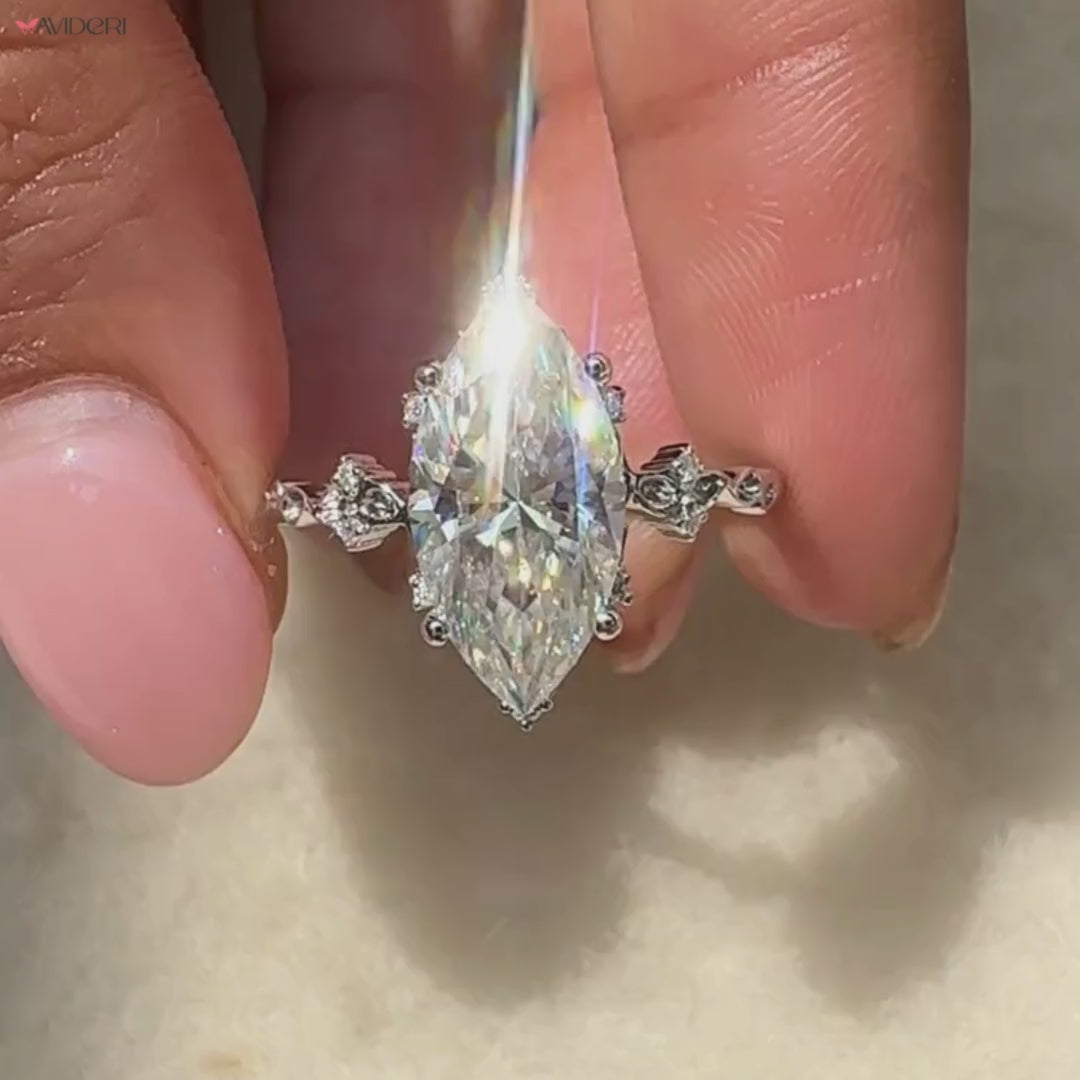 Cluster moissanite ring with round accents in smooth white gold.