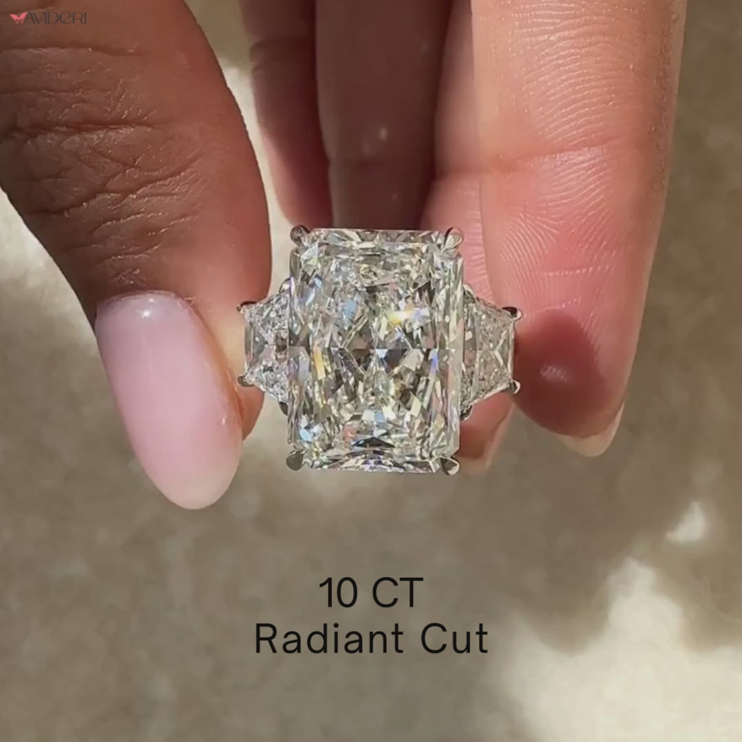 Three stone diamond ring with four claw prong setting.