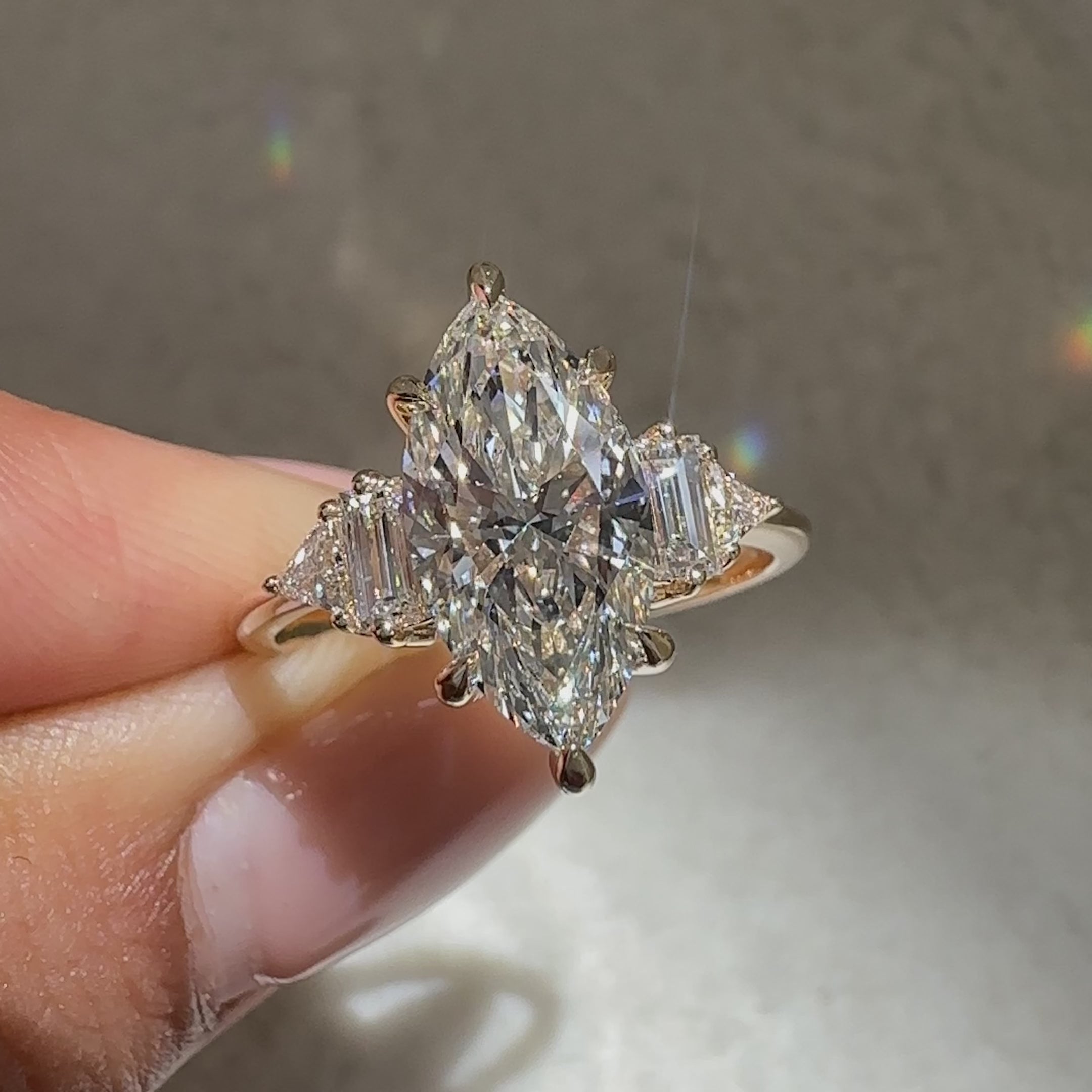 Avideri marquise diamond ring with tapered shank and accents.
