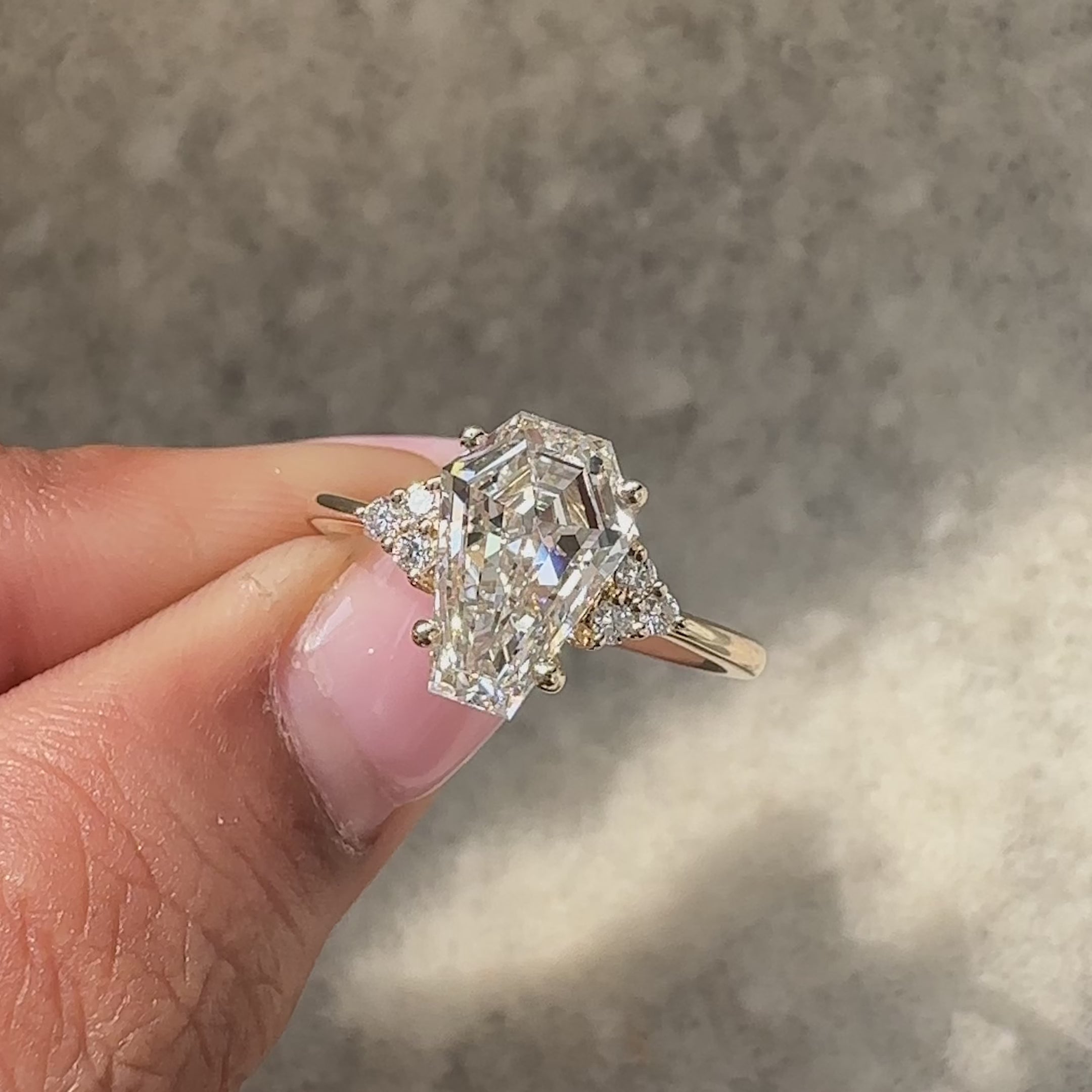 Coffin cut seven stone ring with round side stones.