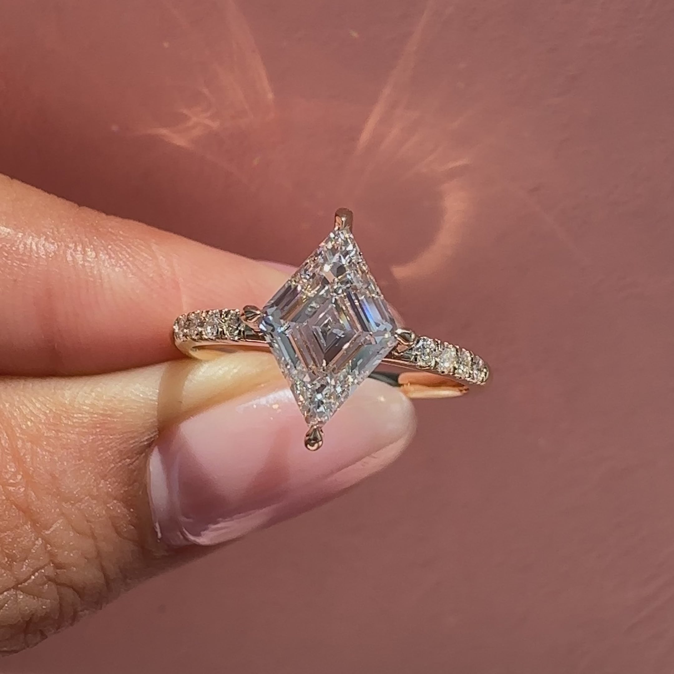 Claw prong lozenge ring with diamond pave.
