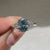 Oval ring with marquise and round side stones.
