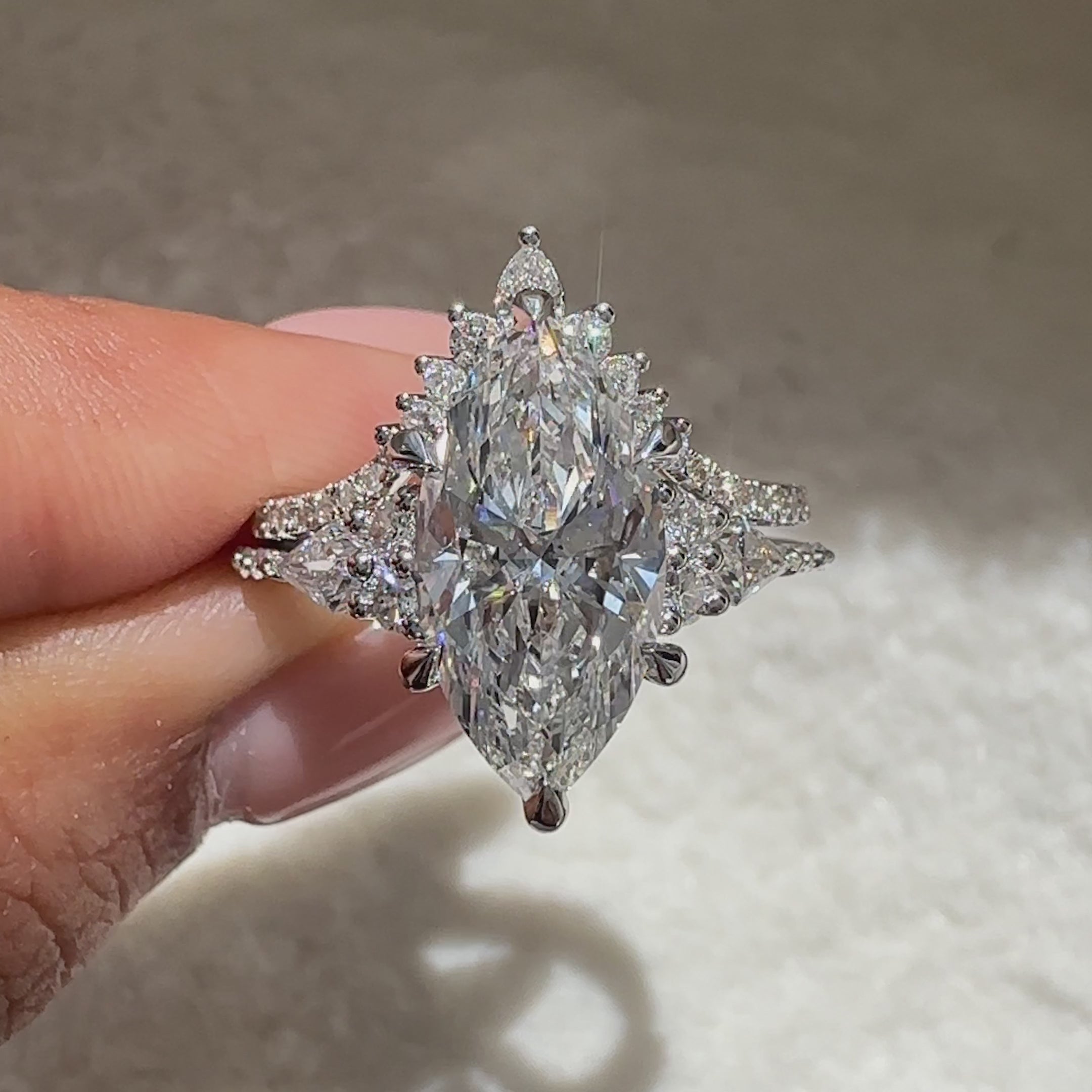 Marquise ring with round diamond pave style.

