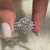 Custom wrap band with shared prongs and white gold finish.