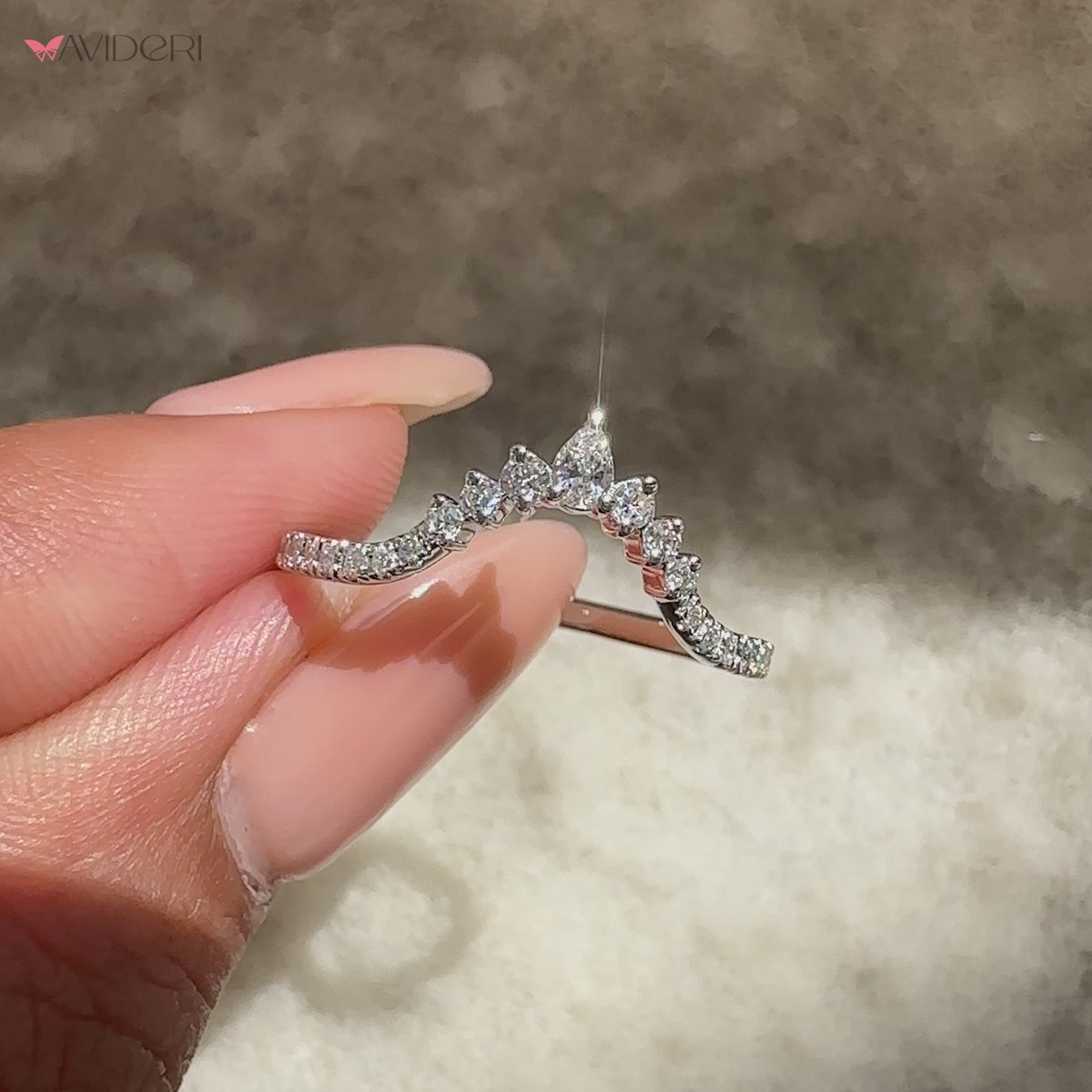 Chevron ring with pear and round diamond accents.
