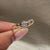 Round diamond ring with tapered band design.
