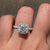 Classic cushion diamond ring with halo design.
