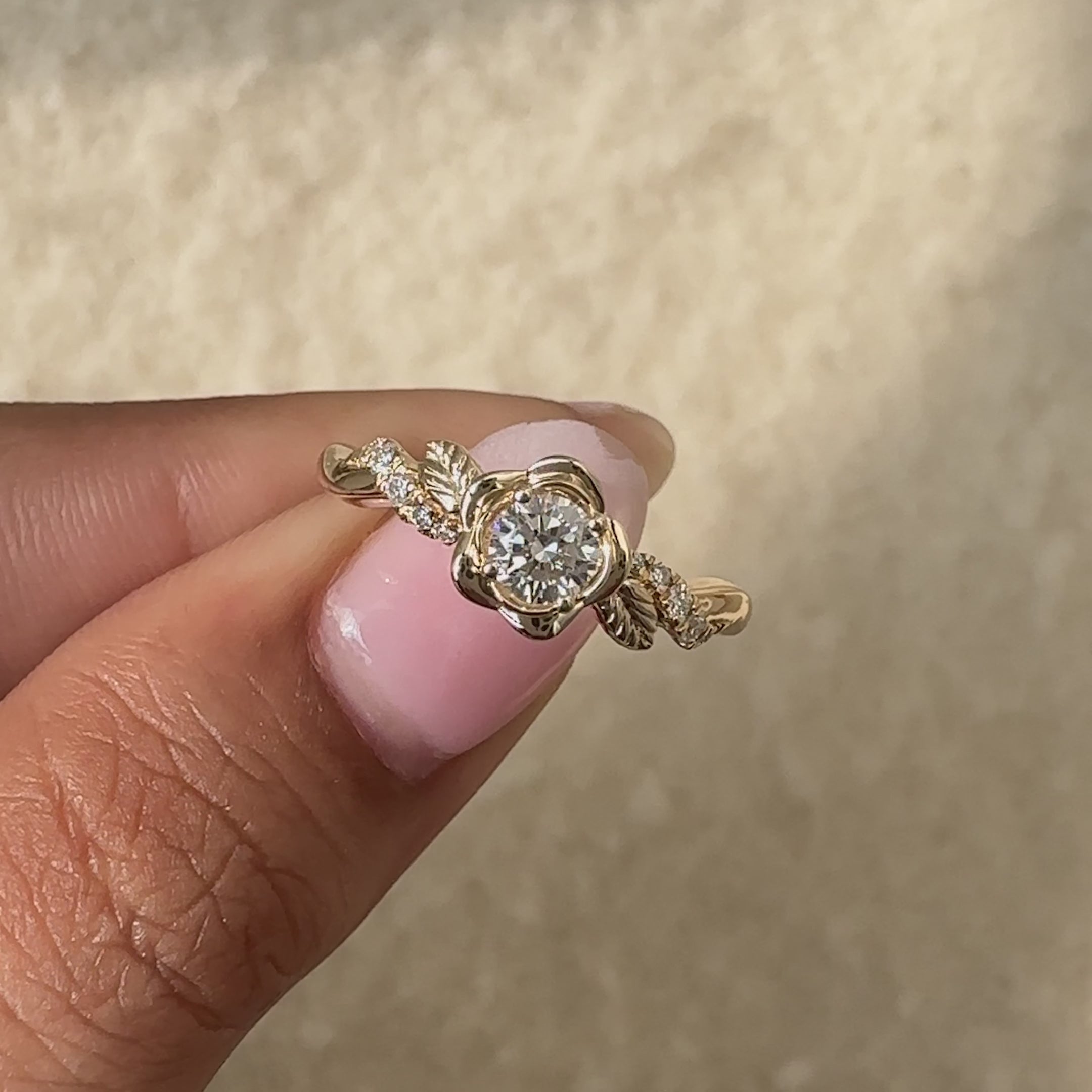 Statement engagement ring with a round diamond and nature-inspired design.