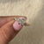 Statement engagement ring with a round diamond and nature-inspired design.