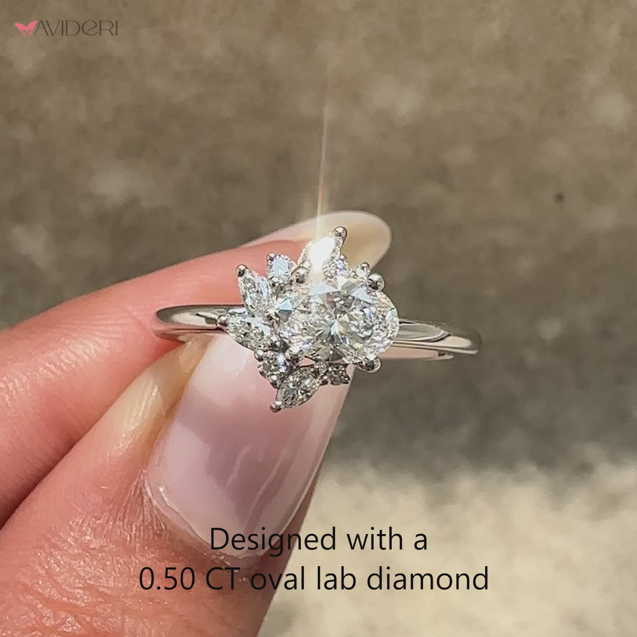 Oval diamond ring with marquise side accents.
