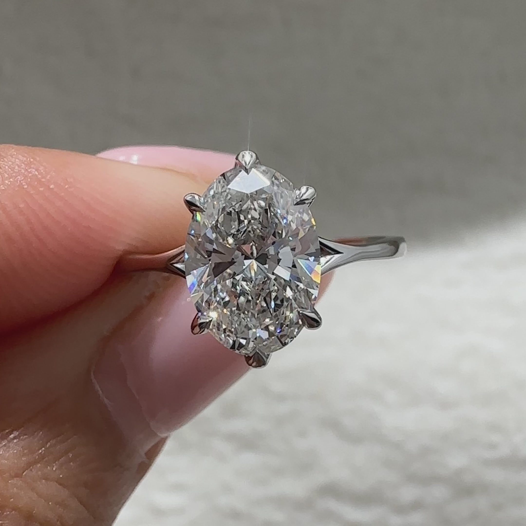 Oval cut ring with split shank and six prongs.
