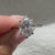 Oval cut ring with split shank and six prongs.
