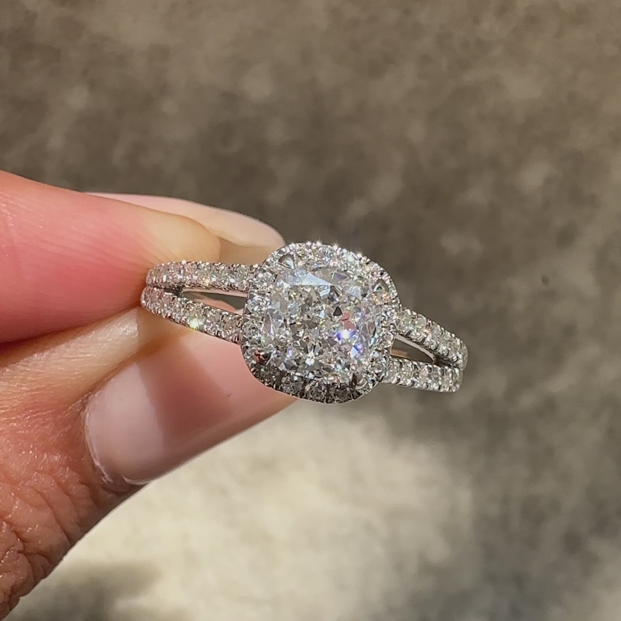 Elegant cushion cut diamond halo cathedral ring.
