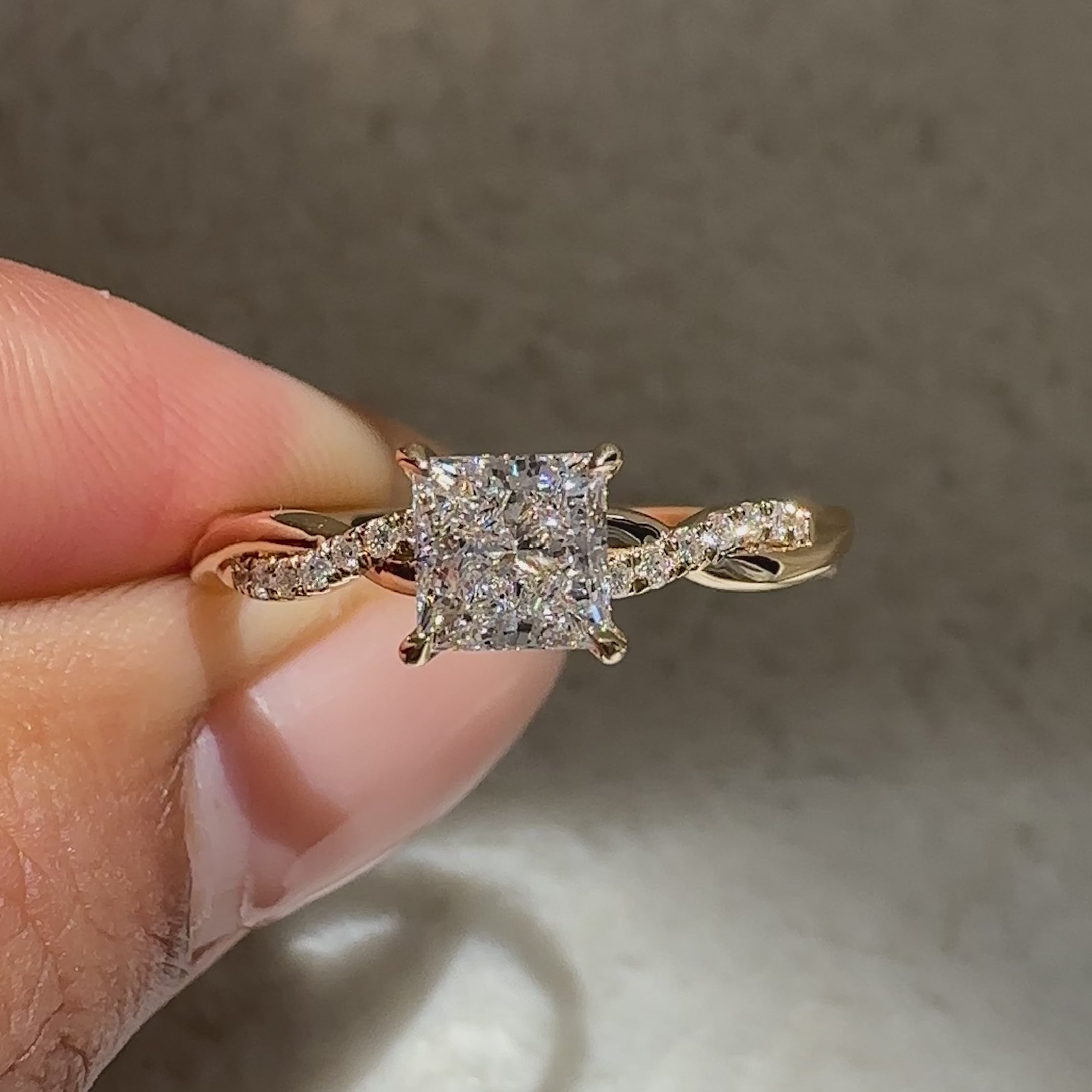 Princess cut ring with basket setting and pave detail

