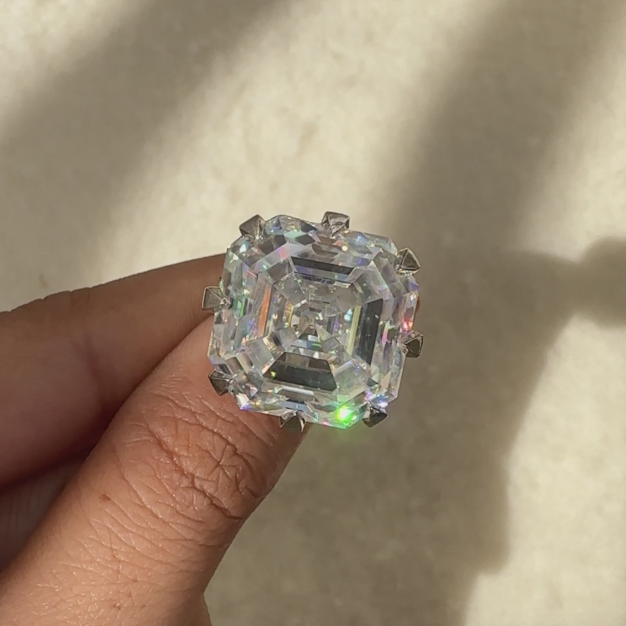 Asscher cut moissanite ring with classic claw setting.