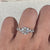 Avideri engagement ring featuring a round and marquise diamond combination, set in a four prong setting.