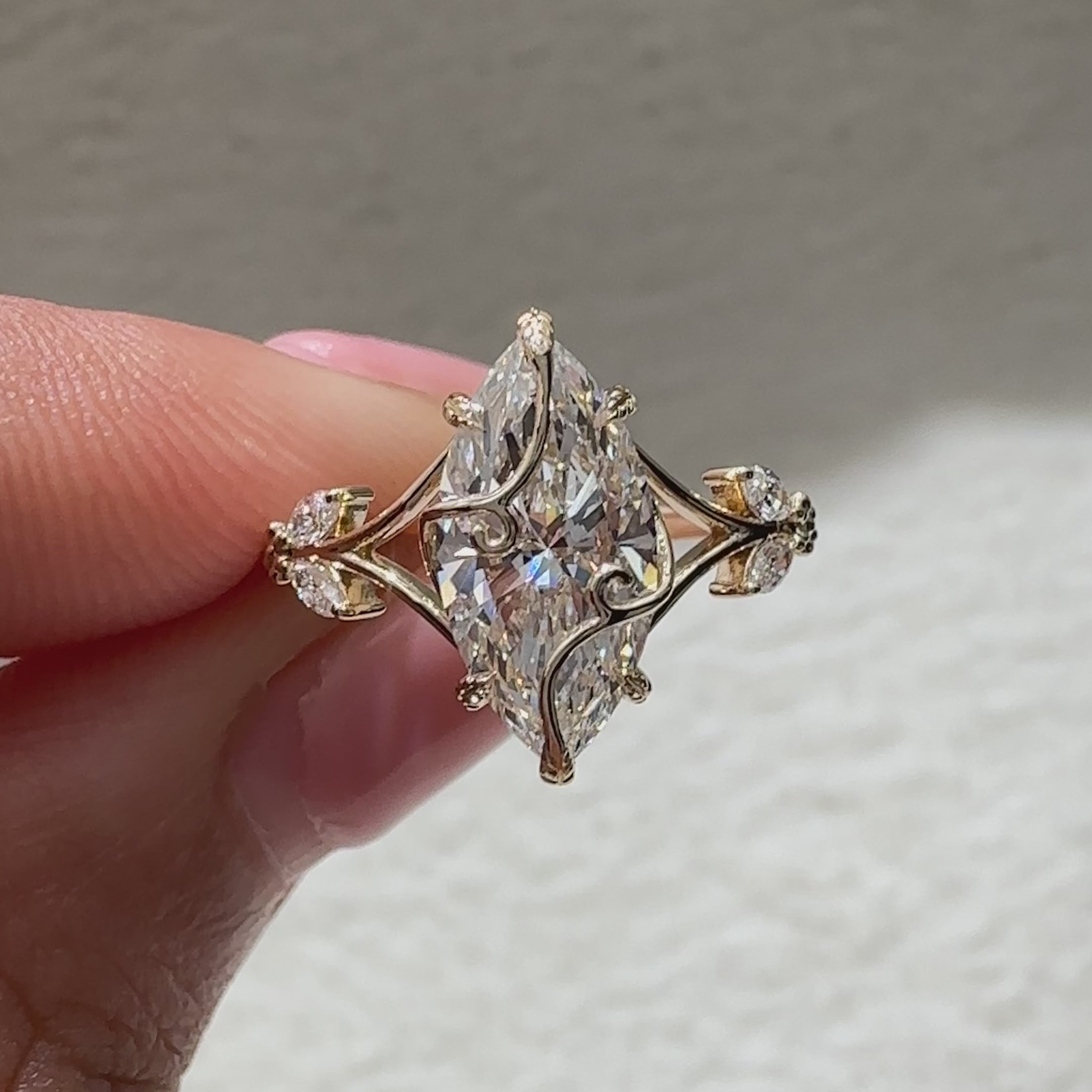 Marquise engagement ring with tapered shank and side stones