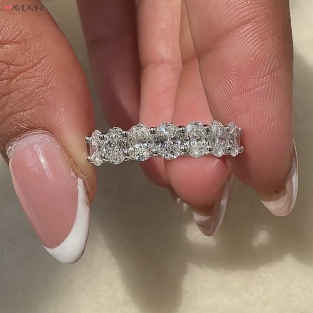 Oval diamond wedding band in half eternity wedding band design.