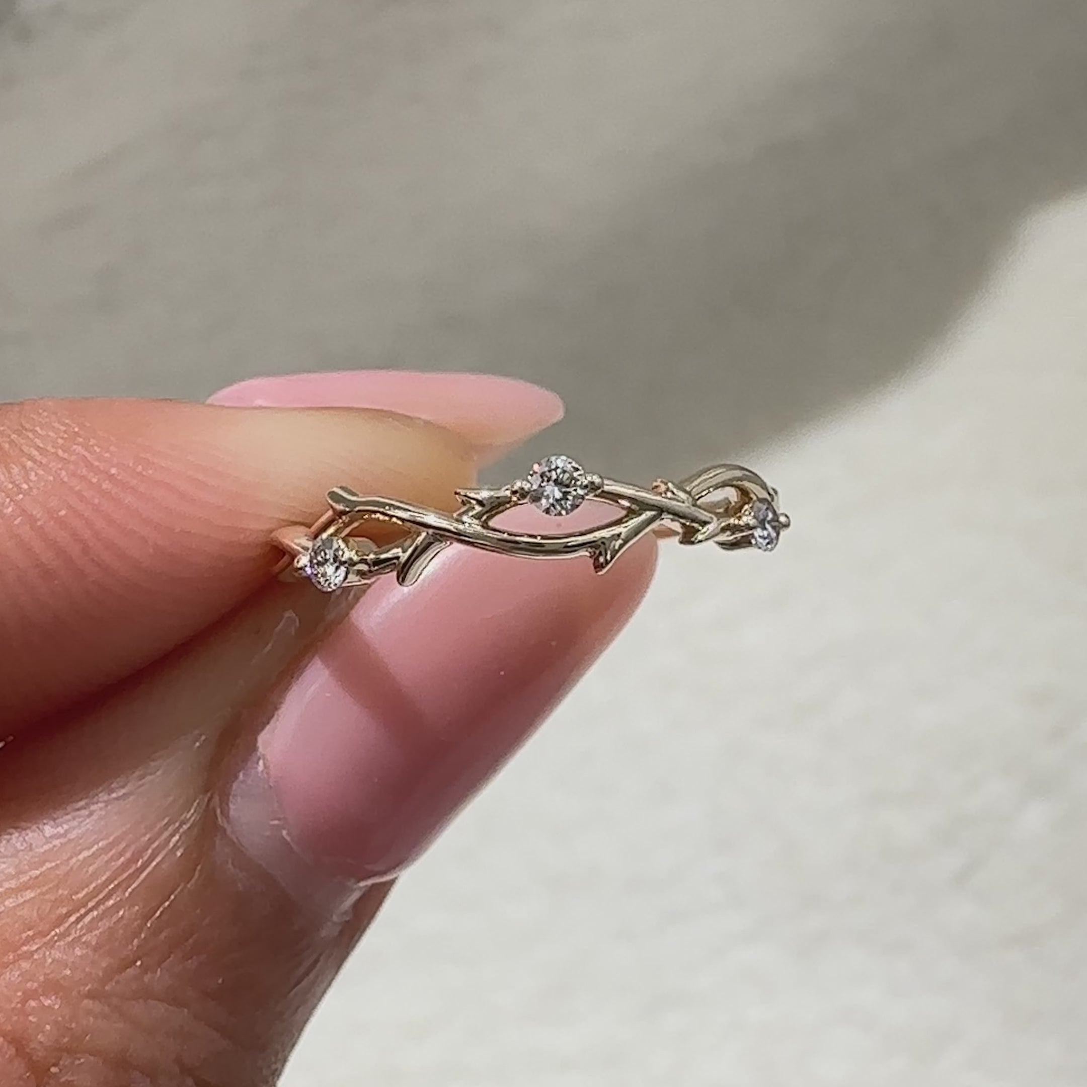 Avideri twisted wedding band with round diamond accents
