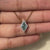 Delicate lozenge moissanite pendant design.
