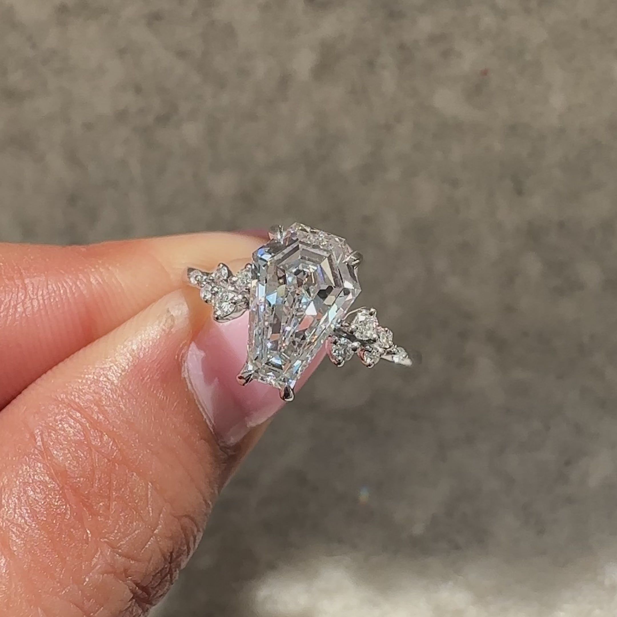 Coffin cut diamond ring with muse and hidden stone style.