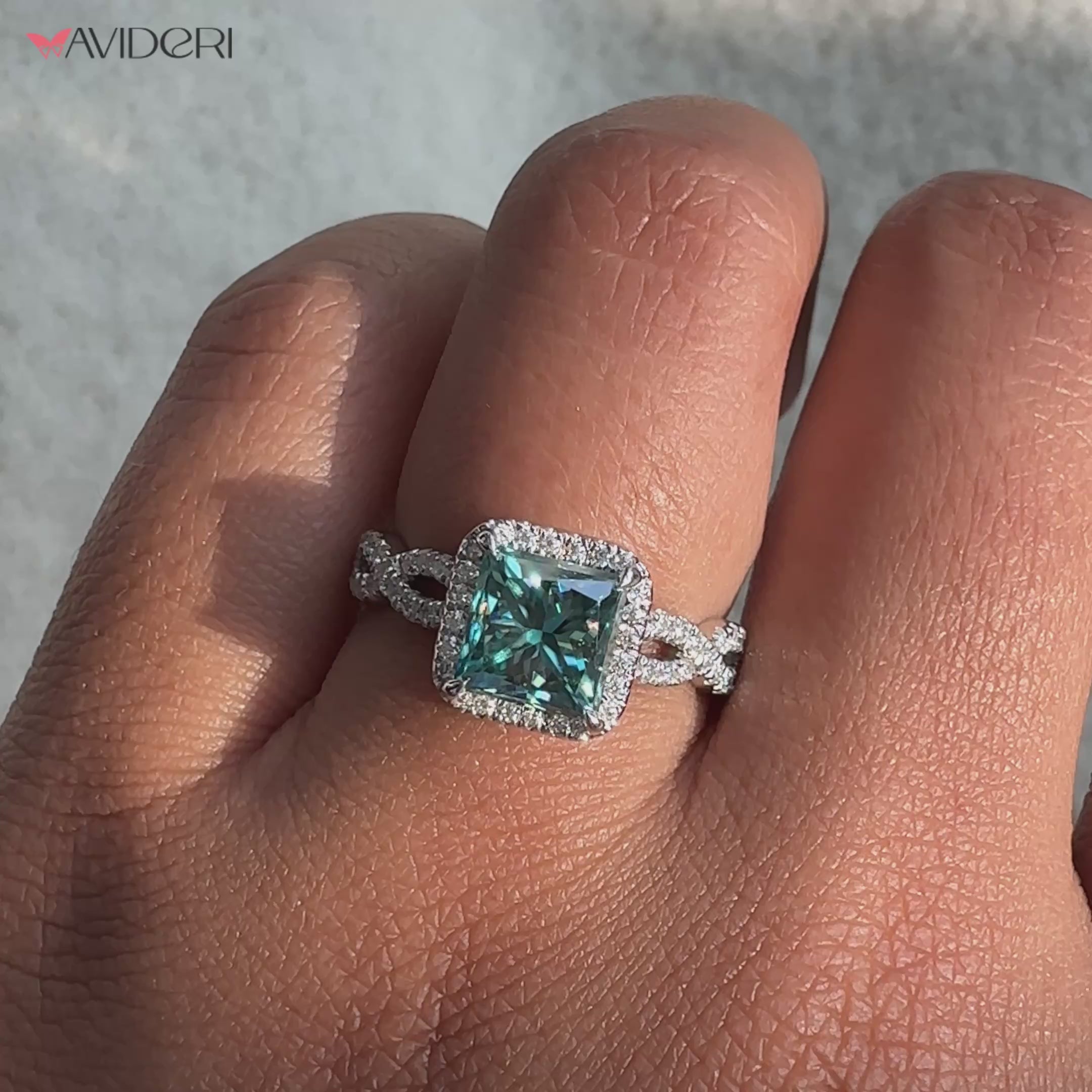 Princess cut moissanite ring featuring a brilliant center stone.
