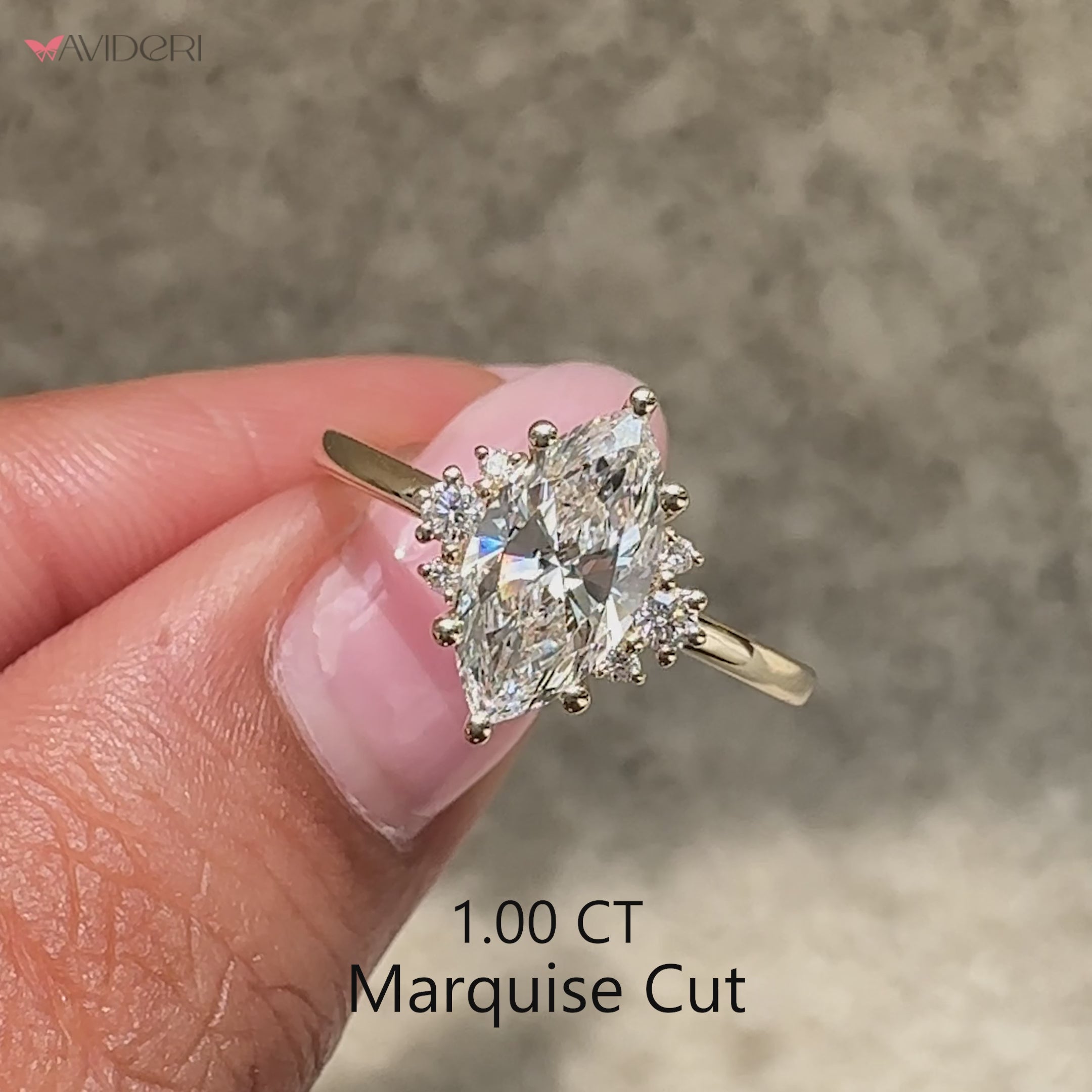 Marquise diamond ring with round side diamond accents.
