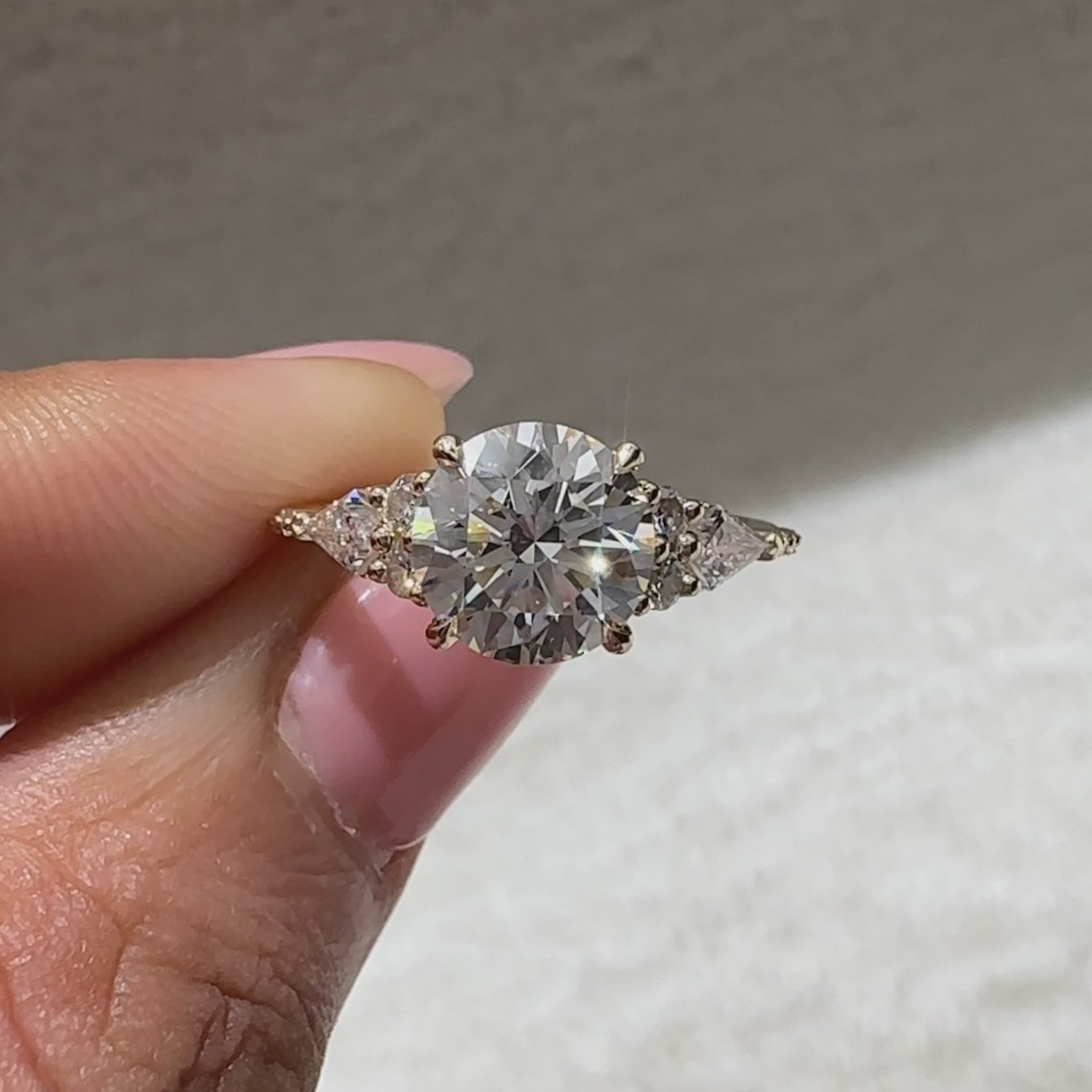 Handmade round cut diamond ring with kite stone accents

