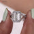 Round cut engagement ring set in a sleek, polished band for a classic look.
