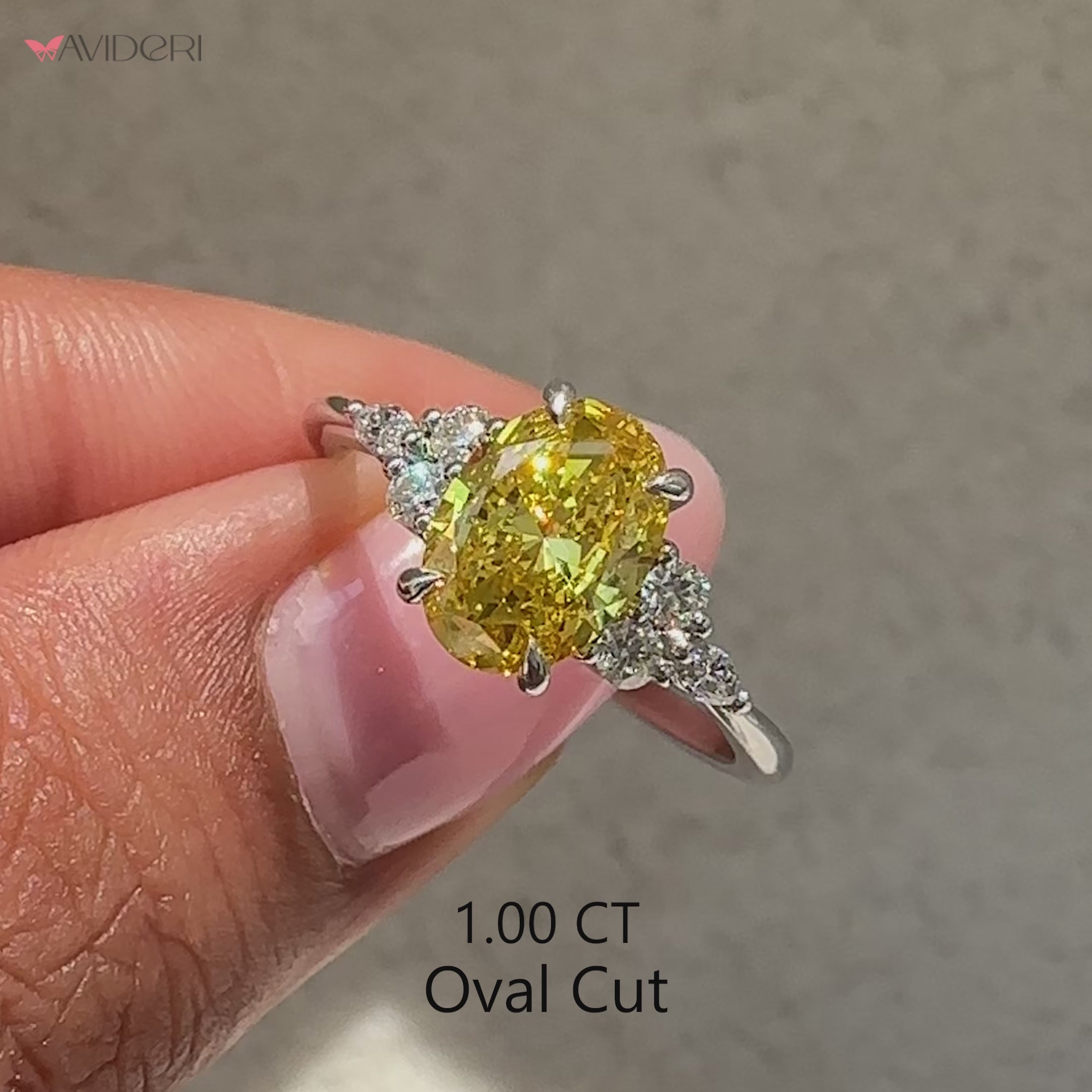 Oval cut yellow diamond ring with marquise and round side stones.