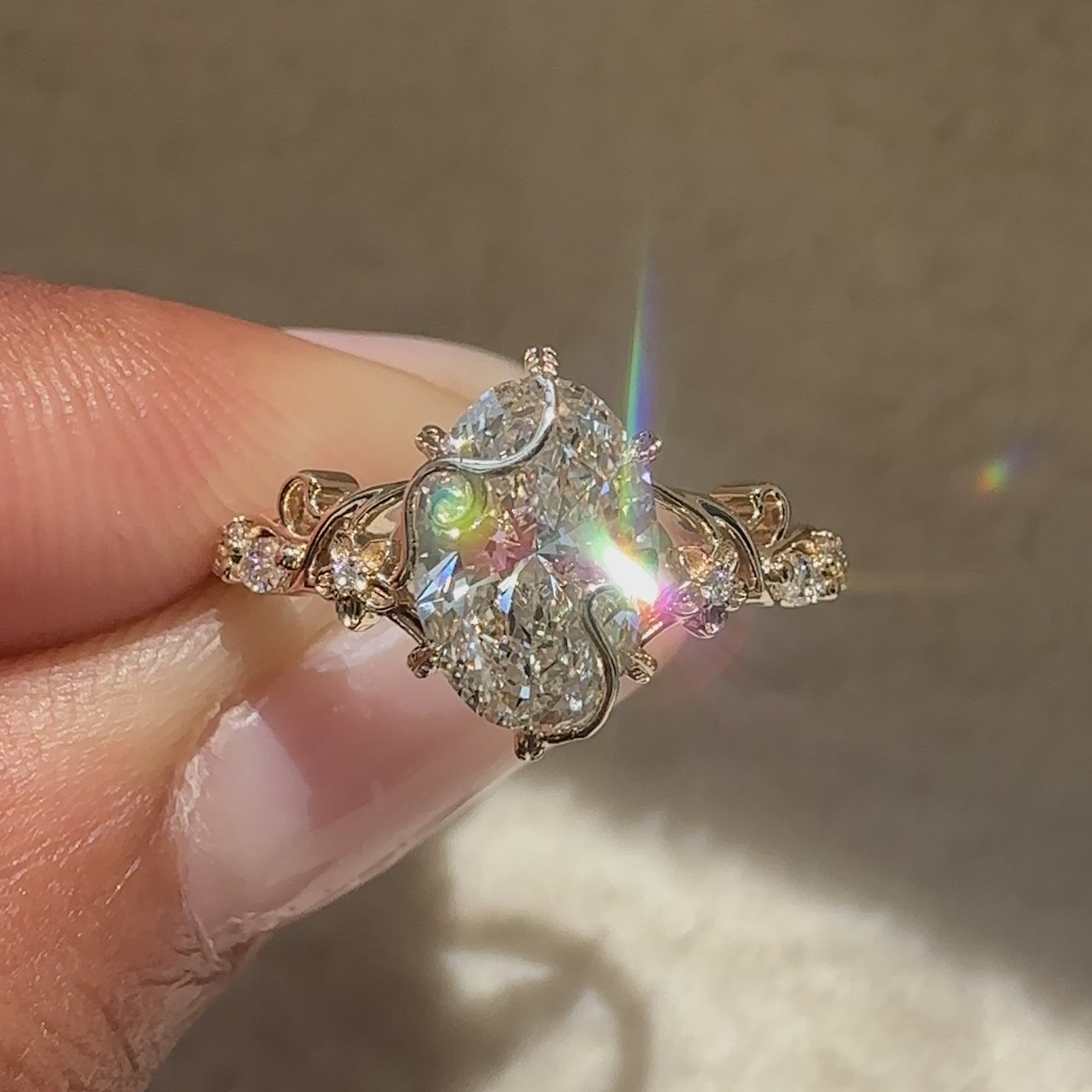 Lab grown oval diamond ring with six leaf prongs.