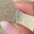 White gold earrings with round diamond pave design.
