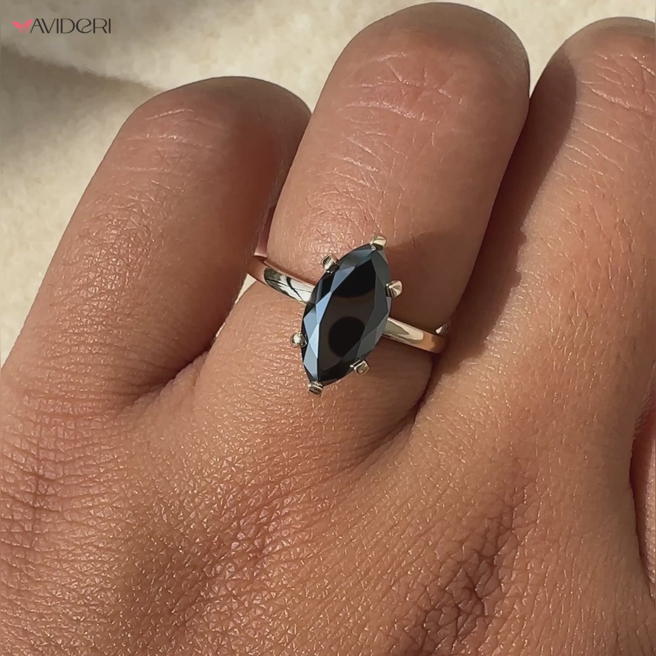 Round cut engagement ring featuring a sparkling marquise moissanite stone.
