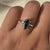 Round cut engagement ring featuring a sparkling marquise moissanite stone.
