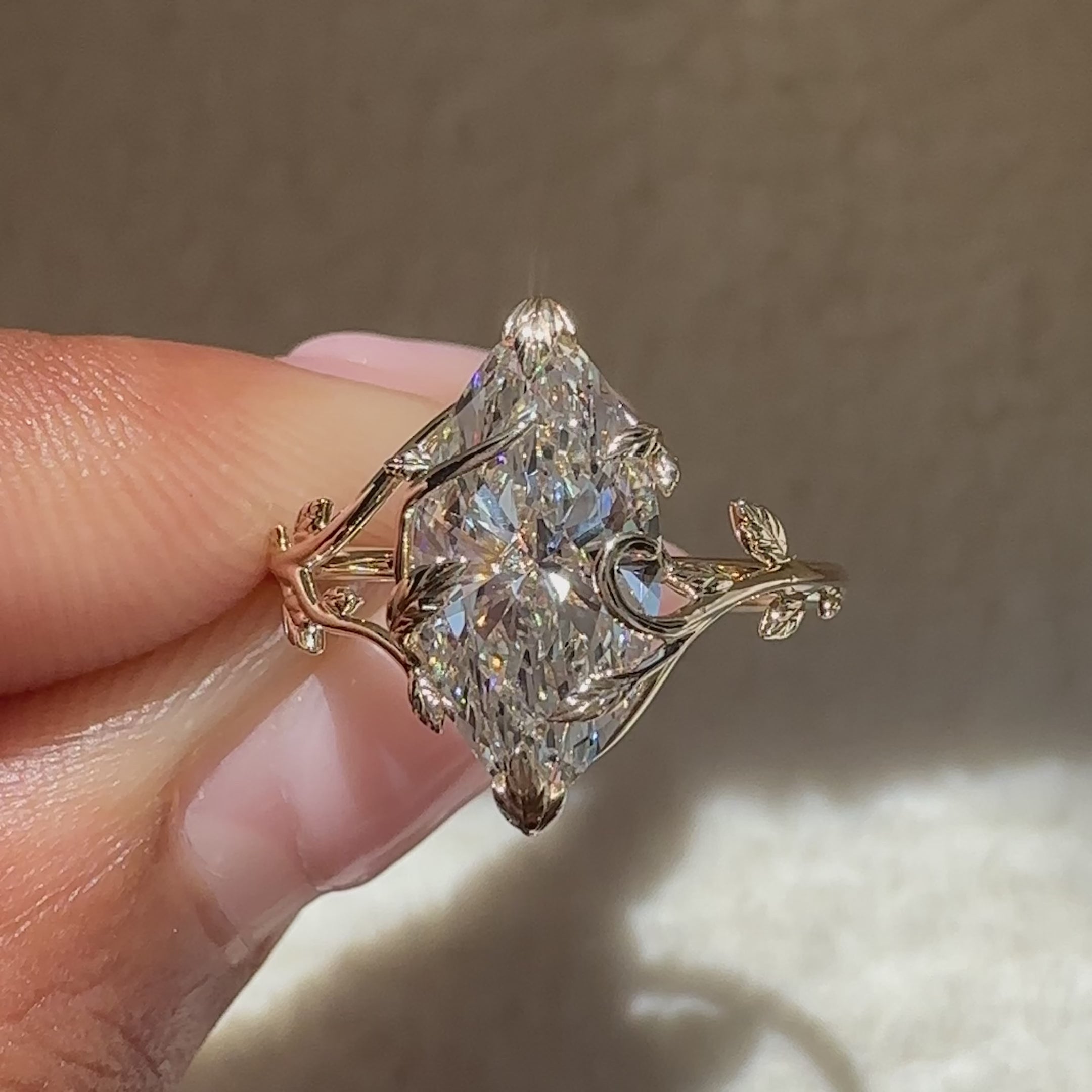 Handmade marquise solitaire ring with leaf prongs.