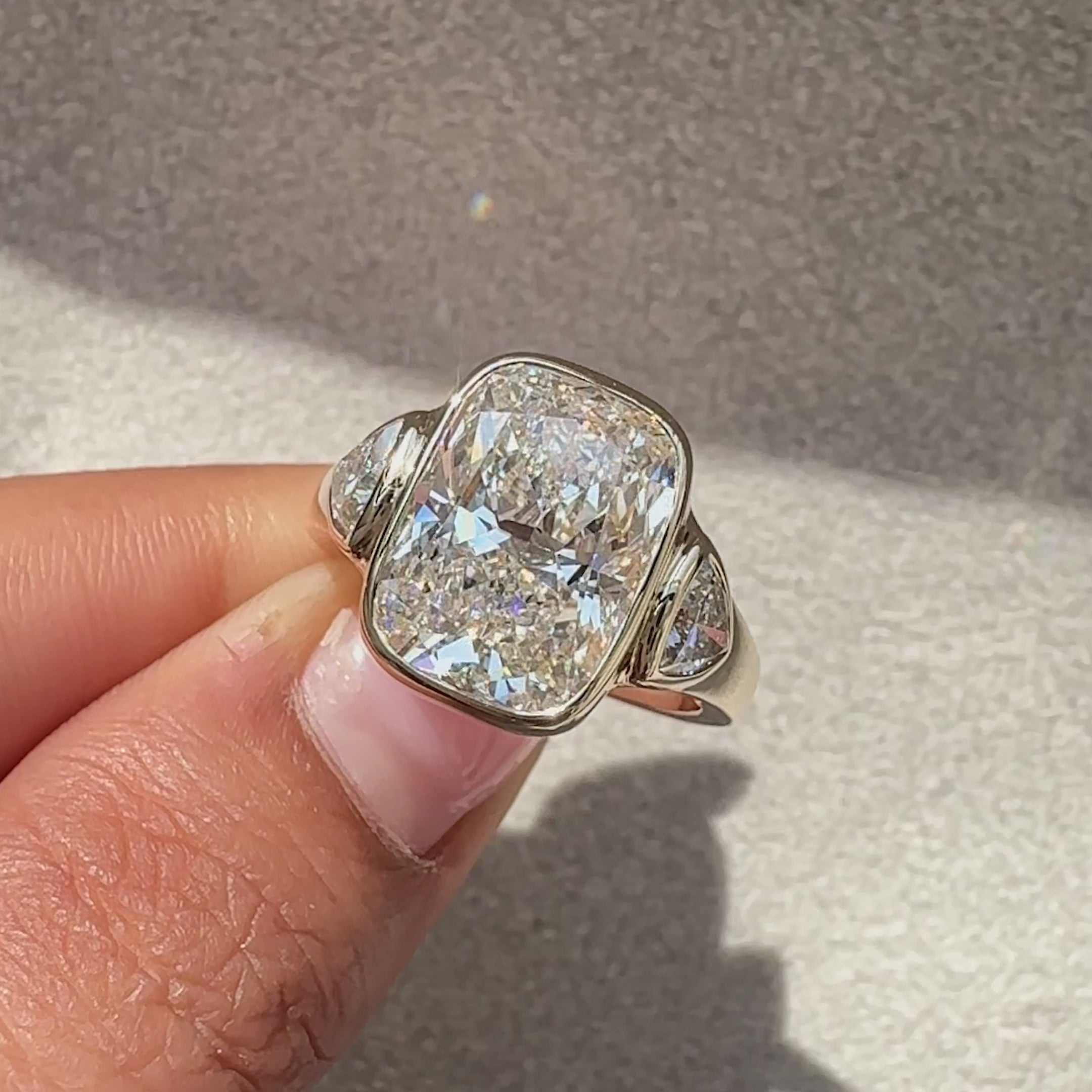 Lab grown cushion cut diamond ring with cathedral setting.
