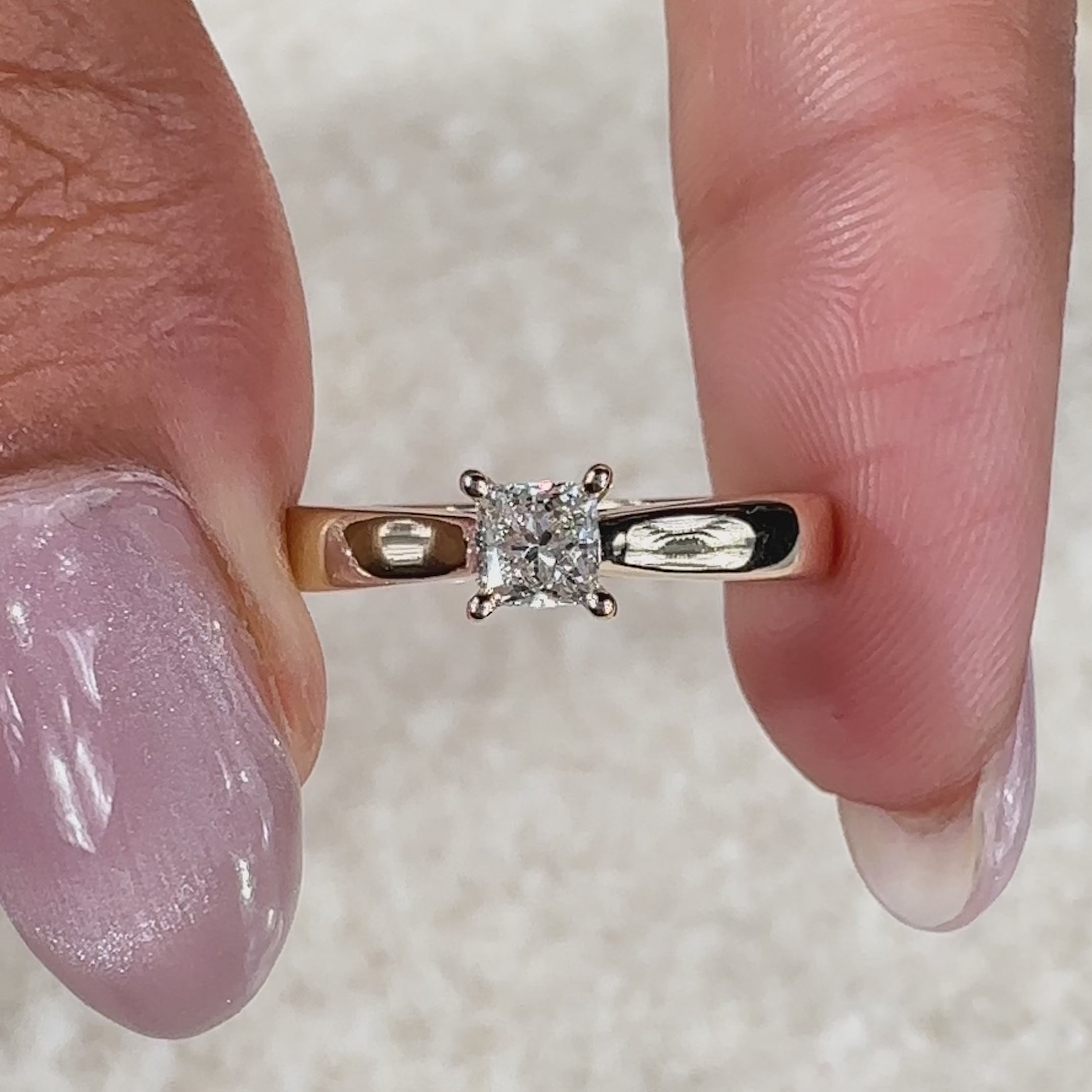 Lab grown diamond engagement ring with a princess diamond, set securely in a four-prong setting.