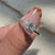 Avideri Engagement Ring with a pear-shaped diamond in a cathedral setting.
