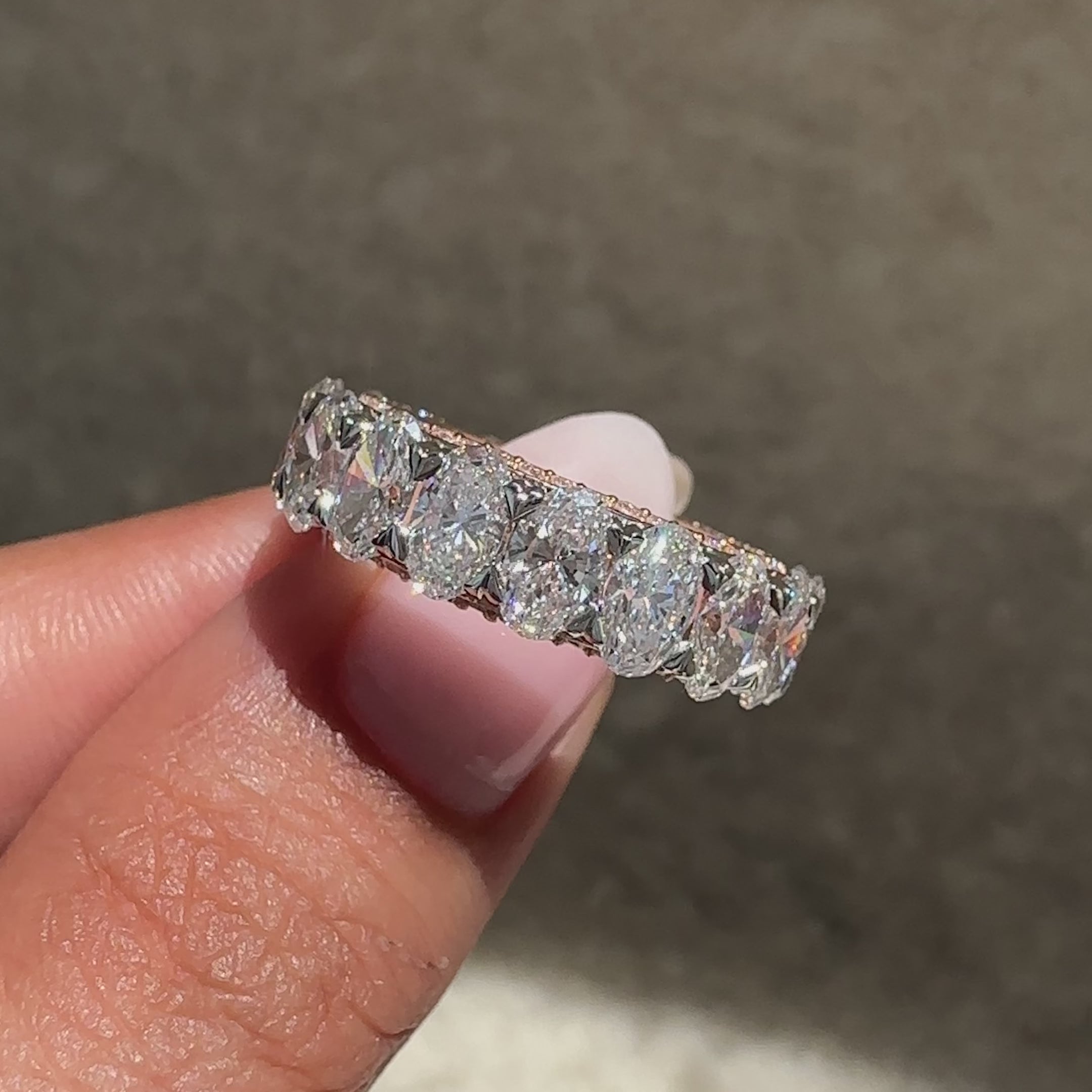 Two tone oval diamond band with round stones.