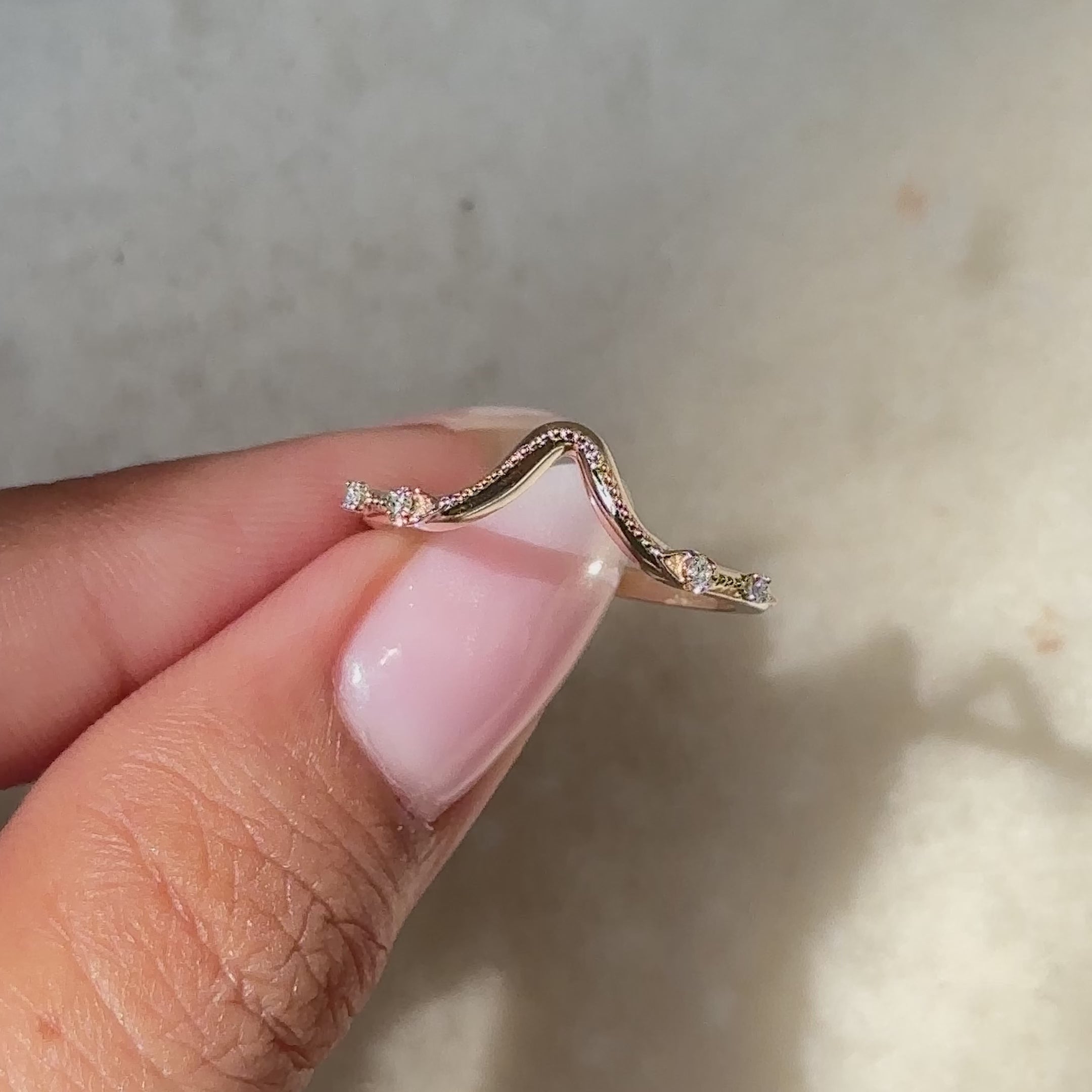 Handmade curved diamond band with four stones.