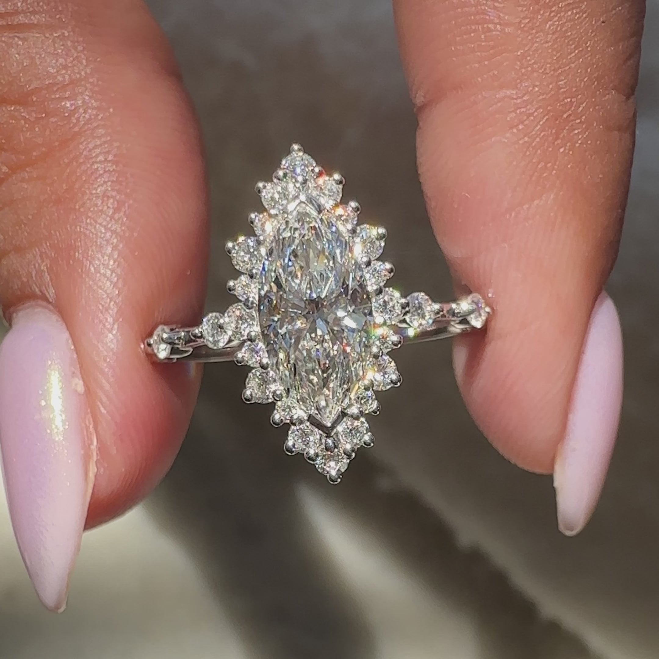 custom white gold engagement ring with round cut diamonds and distance pave band.