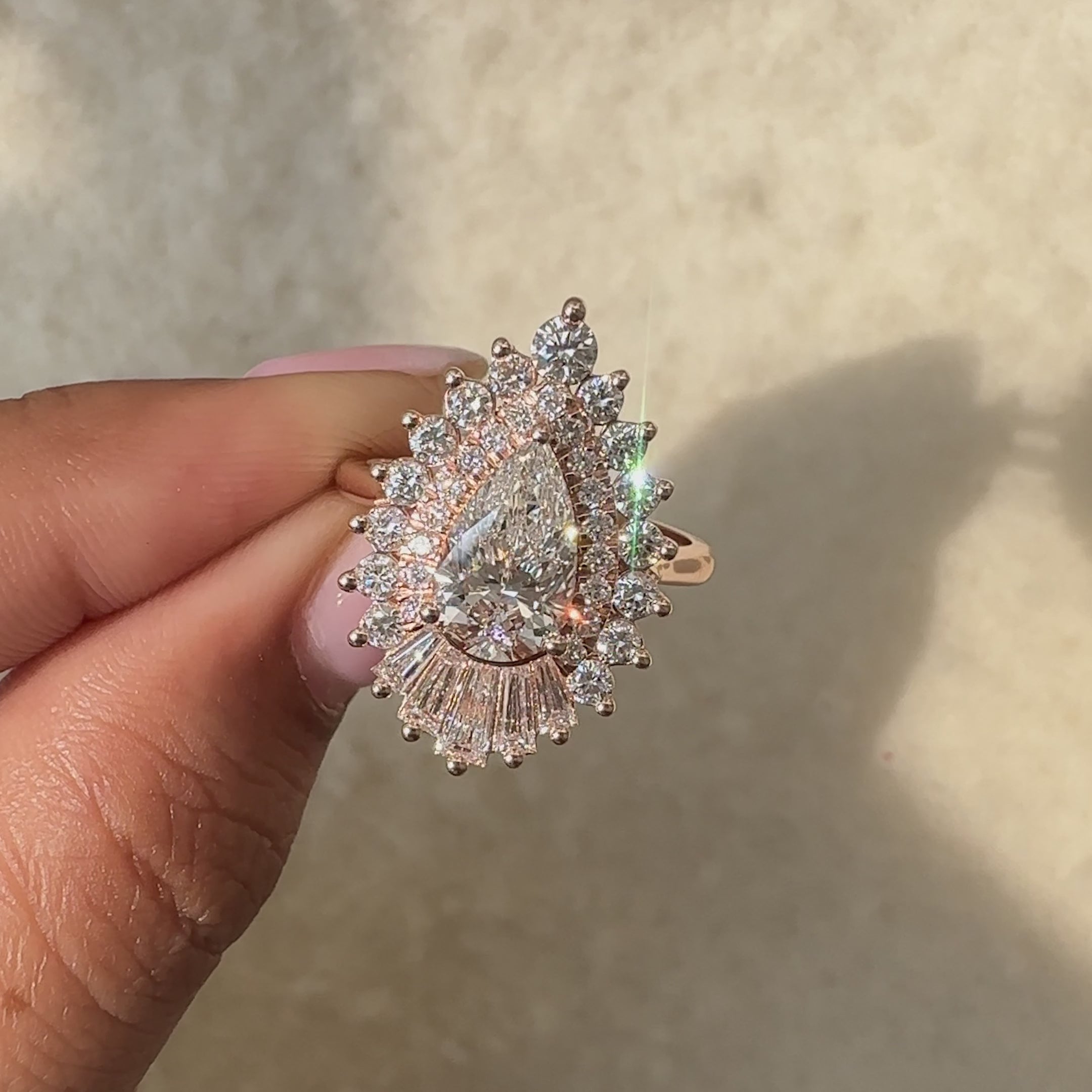 Avideri pear cut diamond ring with round halo and baguette accents.