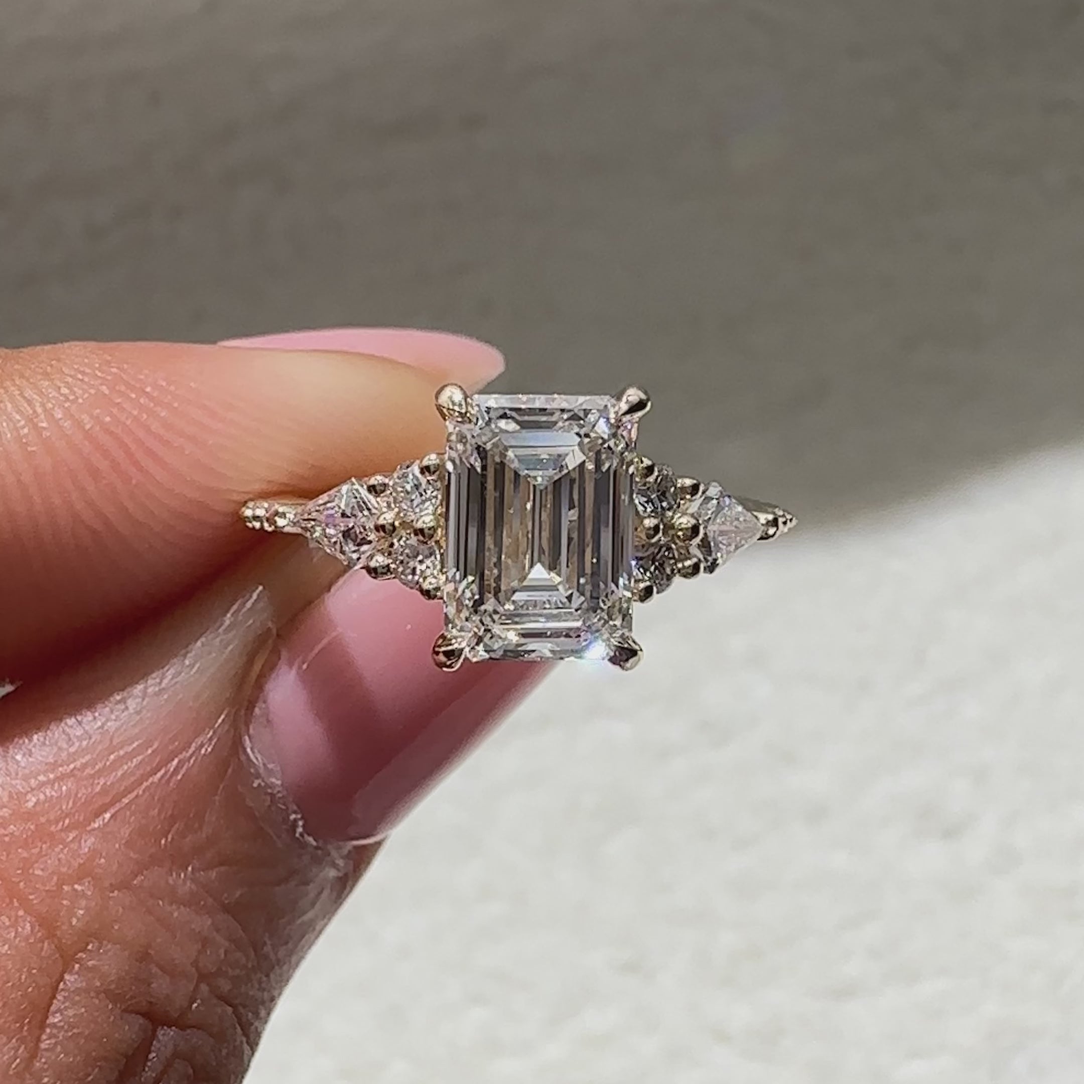 Lab grown emerald ring with muse setting and prongs
