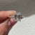 Lab grown emerald ring with muse setting and prongs
