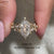 Marquise and round side stone in dutch marquise engagement ring.