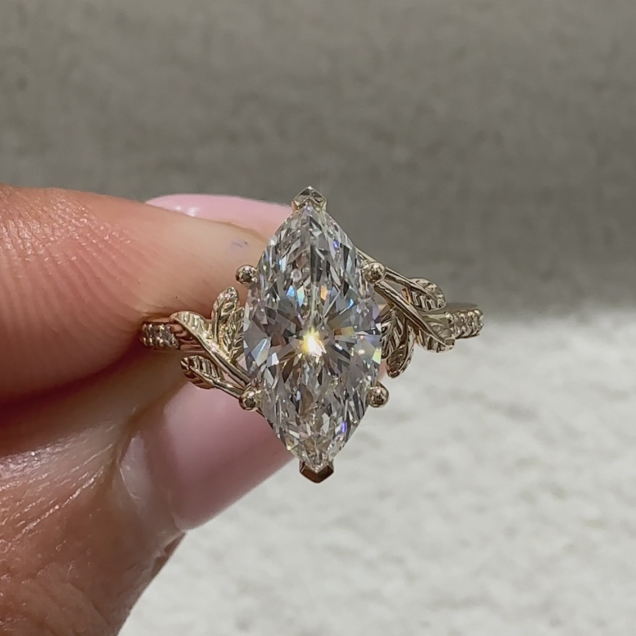 Marquise cut diamond ring with pave and leaf details
