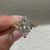 Marquise cut diamond ring with pave and leaf details
