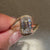 Emerald cut diamond ring with engraved band.
