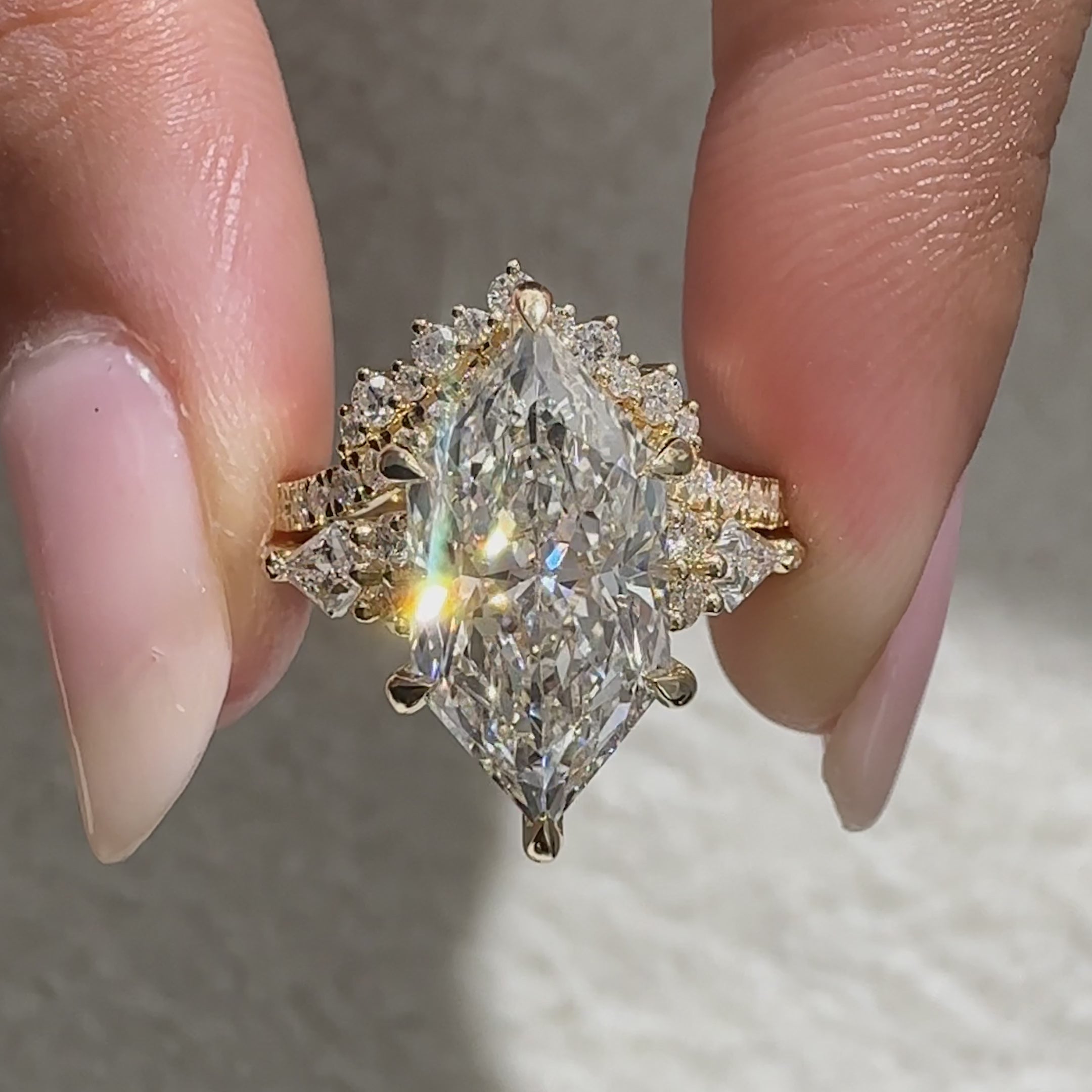 Muse setting Dutch marquise ring with side stones.
