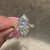 Three stone diamond ring with balanced marquise center and sides.
